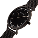 Sofisticado reloj de mujer con correa de malla negra y elegante esfera negra de la marca de joyería española Melona. Colección ALMA MESH