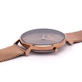 Reloj minimalista de mujer con correa de malla bronce y esfera bronce de la marca de joyería española Melona