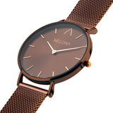 Reloj minimalista de mujer con correa de malla café y esfera café de la marca de joyería española Melona