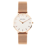 Reloj minimalista de mujer con correa de malla oro rosa y esfera blanca de la marca de joyería española Melona